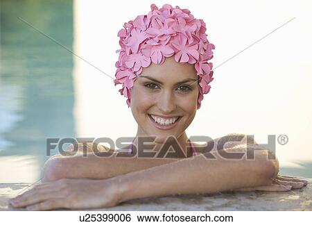 A woman in a swimming hat in a pool View Large Photo Image Stock Photograph - A woman in a swimming hat in a pool. Fotosearch