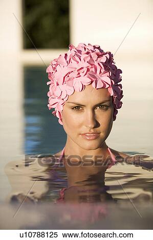 Stock Photography - A woman in a swimming hat in a pool. Fotosearch