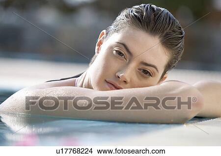 A woman relaxing in a pool View Large Photo Image Picture - A woman relaxing in a pool. Fotosearch
