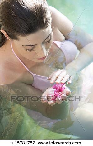A woman wearing a bikini in a pool View Large Photo Image Stock Image - A woman wearing a bikini in a pool. Fotosearch