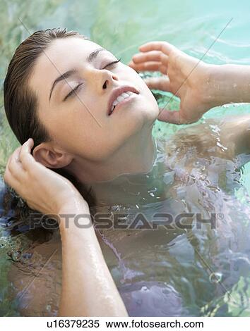 A woman wearing a bikini in a pool View Large Photo Image Stock Photography - A woman wearing a bikini in a pool. Fotosearch