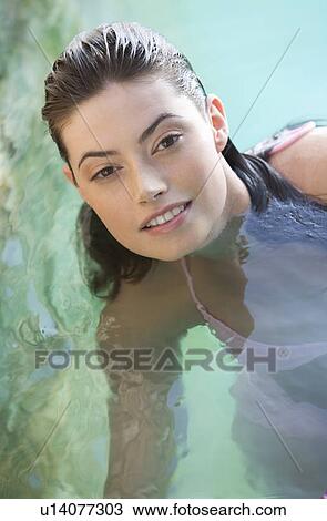 A woman wearing a bikini relaxing in a pool View Large Photo Image Stock Image - A woman wearing a bikini relaxing in a pool. Fotosearch