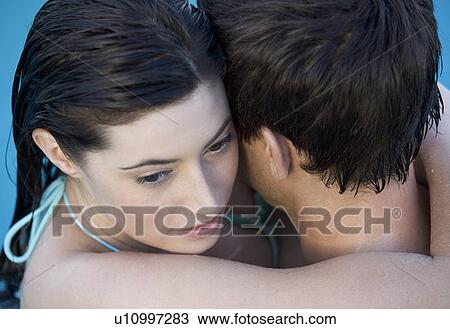 A couple embracing in a pool View Large Photo Image Stock Image - A couple embracing in a pool. Fotosearch