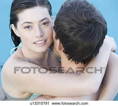 A couple embracing in a pool View Large Photo Image Stock Image - A couple embracing in a pool. Fotosearch