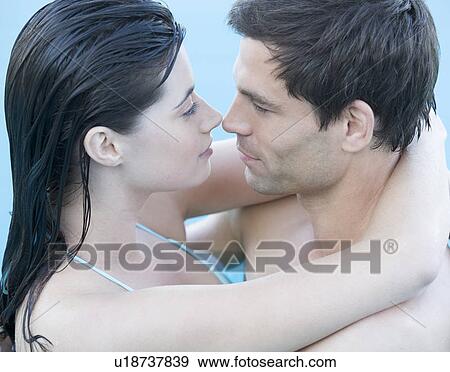 Stock Photo - A couple embracing in a pool. Fotosearch