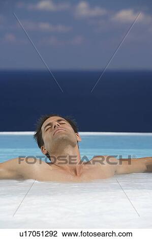 A man relaxing in a jacuzzi View Large Photo Image Stock Image - A man relaxing in a jacuzzi. Fotosearch