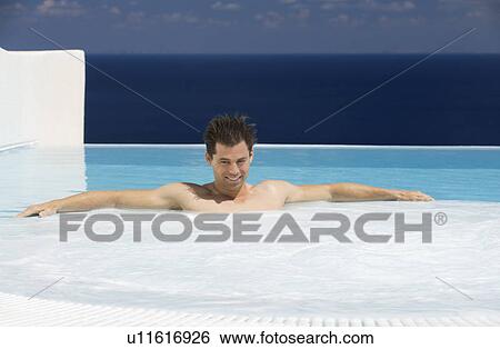 A man relaxing in a jacuzzi View Large Photo Image Stock Photograph - A man relaxing in a jacuzzi. Fotosearch
