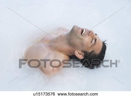 A man relaxing in a jacuzzi View Large Photo Image Stock Photograph - A man relaxing in a jacuzzi. Fotosearch