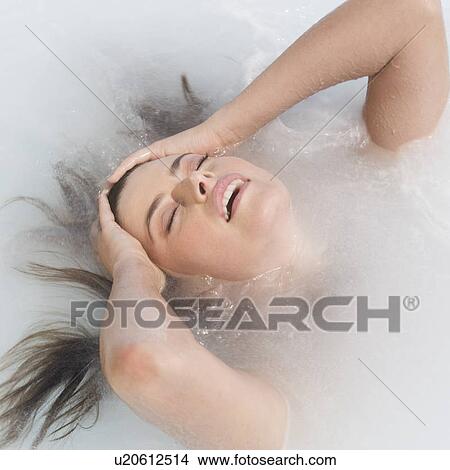 A woman relaxing in a jacuzzi View Large Photo Image Picture - A woman relaxing in a jacuzzi. Fotosearch