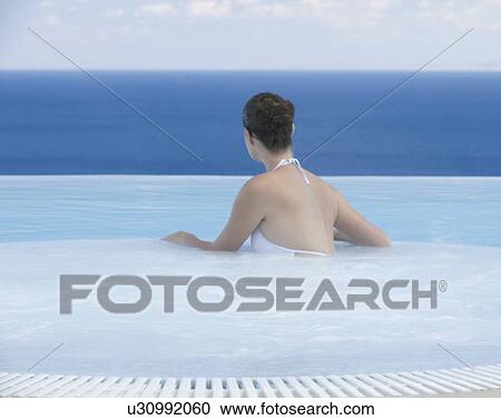 A woman relaxing in a jacuzzi View Large Photo Image Stock Image - A woman relaxing in a jacuzzi. Fotosearch