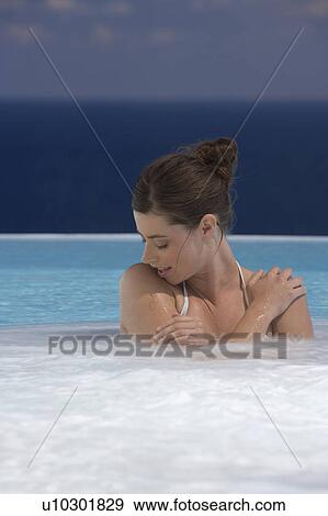 A woman relaxing in a jacuzzi View Large Photo Image Stock Photo - A woman relaxing in a jacuzzi. Fotosearch