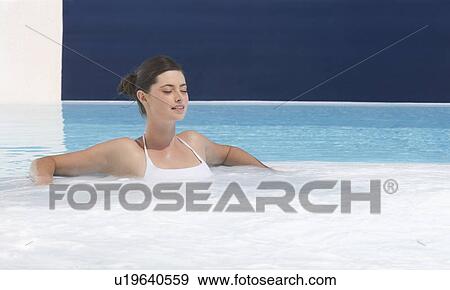 A woman relaxing in a jacuzzi View Large Photo Image Stock Photo - A woman relaxing in a jacuzzi. Fotosearch