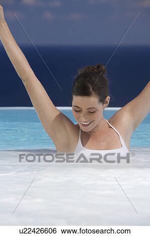 A woman relaxing in a jacuzzi View Large Photo Image Stock Photograph - A woman relaxing in a jacuzzi. Fotosearch