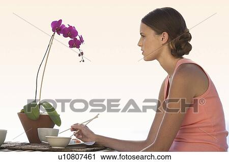 A young woman eating sushi View Large Photo Image Stock Image - A young woman eating sushi. Fotosearch