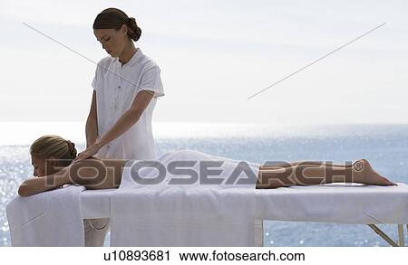 A young woman having a massage View Large Photo Image Stock Image - A young woman having a massage. Fotosearch