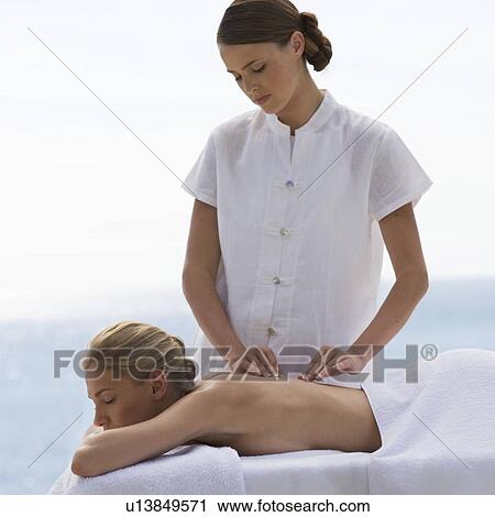 Stock Image - A young woman having a massage. Fotosearch
