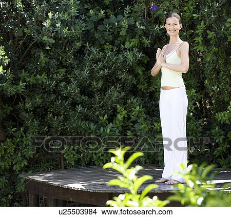 Picture - A young woman practicing yoga. Fotosearch