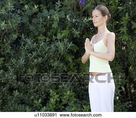 A young woman practicing yoga View Large Photo Image Stock Image - A young woman practicing yoga. Fotosearch