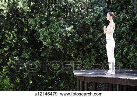 A young woman practicing yoga View Large Photo Image Stock Photo - A young woman practicing yoga. Fotosearch