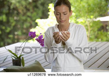 A young woman sitting in a garden View Large Photo Image Stock Photo - A young woman sitting in a garden. Fotosearch