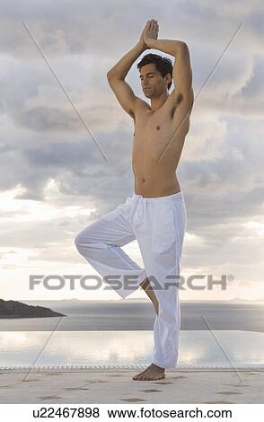 A man doing yoga by a pool View Large Photo Image Stock Photo - A man doing yoga by a pool. Fotosearch