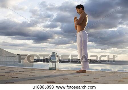 A man meditating by a pool View Large Photo Image Stock Image - A man meditating by a pool. Fotosearch
