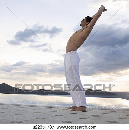 A man stretching by a pool View Large Photo Image Stock Photo - A man stretching by a pool. Fotosearch