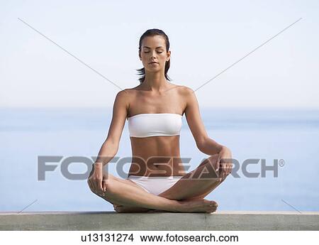 A young woman practicing yoga View Large Photo Image Picture - A young woman practicing yoga. Fotosearch
