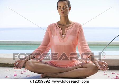 A young woman practicing yoga View Large Photo Image Stock Image - A young woman practicing yoga. Fotosearch