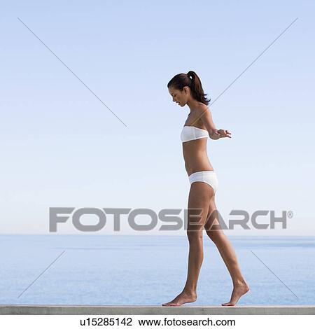 Stock Image - A young woman practicing yoga. Fotosearch