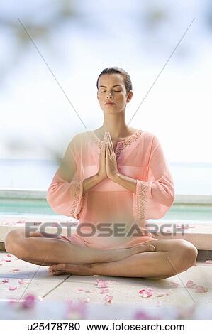 A young woman practicing yoga View Large Photo Image Stock Image - A young woman practicing yoga. Fotosearch