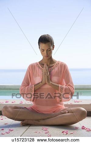 A young woman practicing yoga View Large Photo Image Stock Photo - A young woman practicing yoga. Fotosearch