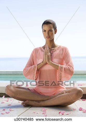 Stock Photography - A young woman practicing yoga. Fotosearch