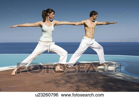 Two people exercising by a pool View Large Photo Image Stock Photograph - Two people exercising by a pool. Fotosearch