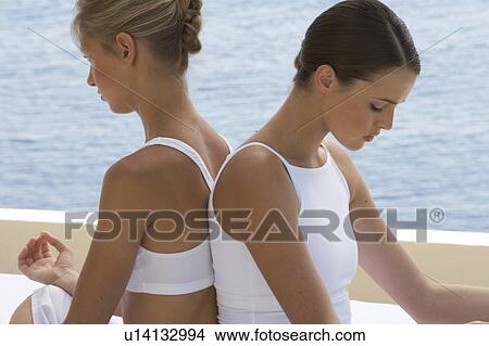 Two young women practicing yoga View Large Photo Image Picture - Two young women practicing yoga. Fotosearch
