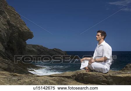 A man meditating by the sea View Large Photo Image Stock Photography - A man meditating by the sea. Fotosearch