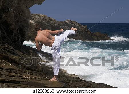 A man practicing Tai Chi by the sea View Large Photo Image Stock Image - A man practicing Tai Chi by the sea. Fotosearch