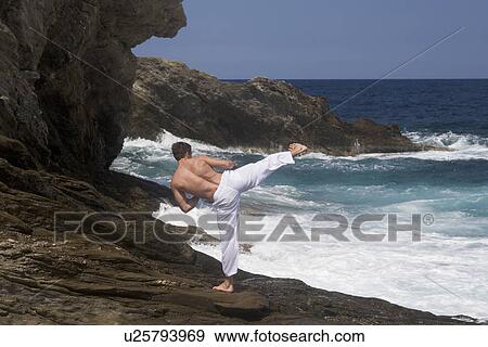 A man practicing Tai Chi by the sea View Large Photo Image Stock Photo - A man practicing Tai Chi by the sea. Fotosearch