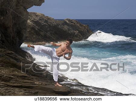 A man practicing Tai Chi by the sea View Large Photo Image Stock Photograph - A man practicing Tai Chi by the sea. Fotosearch