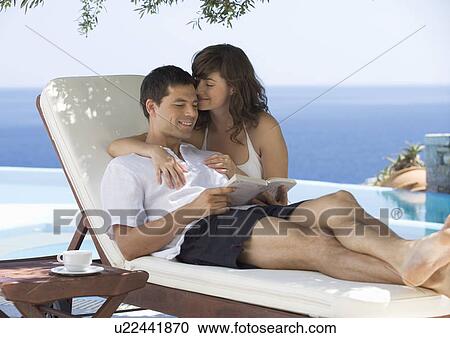 A couple relaxing by a pool View Large Photo Image Stock Image - A couple relaxing by a pool. Fotosearch