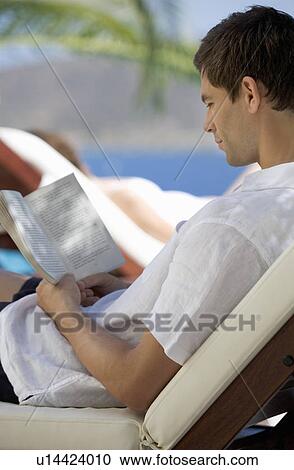 A man relaxing on a sun lounger View Large Photo Image Stock Image - A man relaxing on a sun lounger. Fotosearch