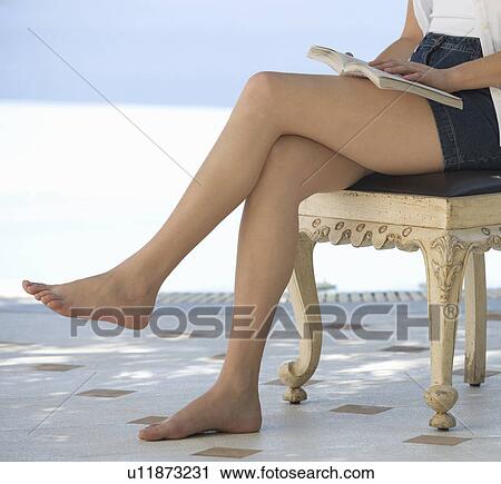 A woman reading by a pool View Large Photo Image Stock Image - A woman reading by a pool. Fotosearch