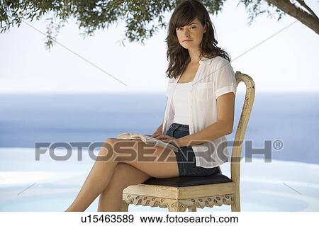A woman reading by a pool View Large Photo Image Stock Photo - A woman reading by a pool. Fotosearch