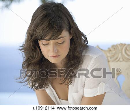Picture - A woman relaxing by a pool. Fotosearch