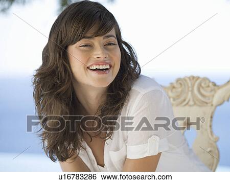 Stock Photograph - A woman relaxing by a pool. Fotosearch