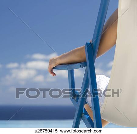 A woman relaxing in a deck chair View Large Photo Image Stock Photography - A woman relaxing in a deck chair. Fotosearch