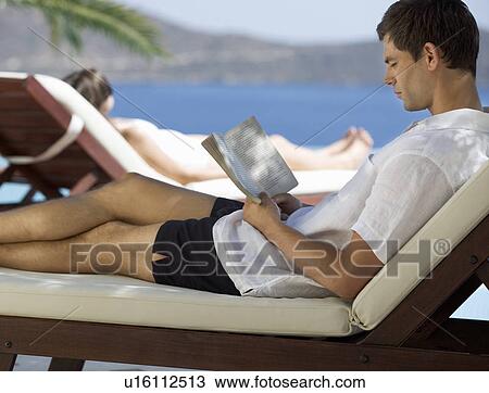 Two people relaxing by a pool View Large Photo Image Stock Image - Two people relaxing by a pool. Fotosearch
