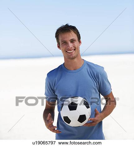 Portrait of a young man with a football View Large Photo Image Stock Photo - Portrait of a young man with a football. Fotosearch