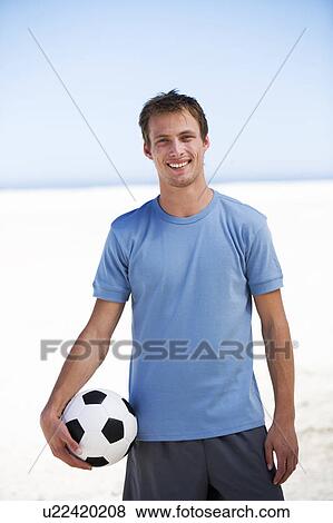 Portrait of a young man with a football View Large Photo Image Stock Photo - Portrait of a young man with a football. Fotosearch