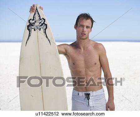 Portrait of a young man with a surf board View Large Photo Image Stock Image - Portrait of a young man with a surf board. Fotosearch
